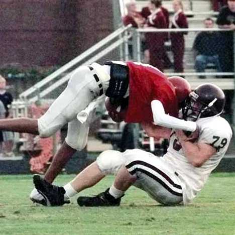Andy Kenney (79) holds on to an unidentified Franklin player during the Lions win over Rebels