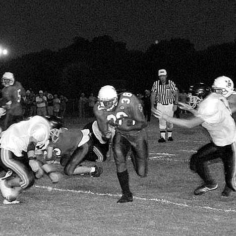 Ellis Dailey (38) blasts through a hole in the Lewis County defense