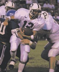 Portland quarterback Richard DePriest (12) is tackled by Tony Misch (30) and Brandon Leftwitch of White House