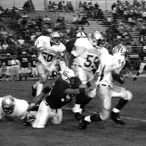 Spring Hill running back David Ransome tries to avoid being pulled down by a Lawrence County defender during the Wildcats 6-0 win