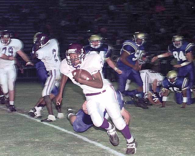 Courtney Crawford (3) slips away from a Shelbyville tackler