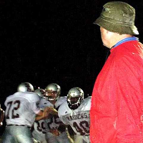 Head coach Bill Cox watches Jared Johnson (72), Montrae Osborne (40) and Chris Dunn (25) go through drills