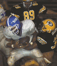 A McGavock runner is taken down by Marcus Williams during 34-7 Green Wave victory