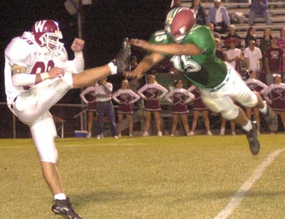 Thomas Lister sails to block a punt Friday night during action with Morristown West