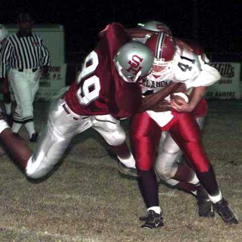 Spring Hill sophomore end Saadiq Ziyad (99) brings down Leslie Eggleston (41)