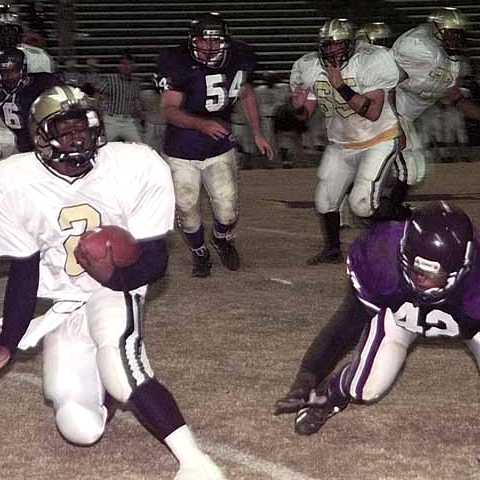 Springfield quarterback Marrico Collier (2) tries to elude Quan Armstrong (42)