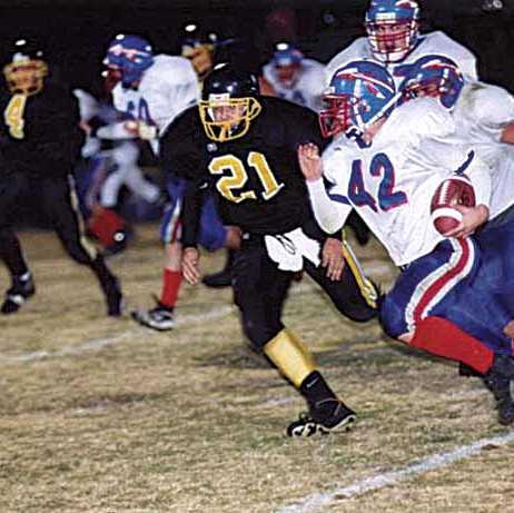 Harpeth running back Brandon Beasley (42) tries to get past Mike Staggs (21)