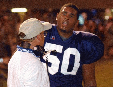 Harriman DT Shea Douglas gets some advice from Blue Devil assistant coach Travis Tapp.