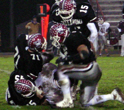 Covering the quarterback is Jason Nixon (45), Zane Hollowell (71), Collin Bills (15) and Chris Peterson (35).