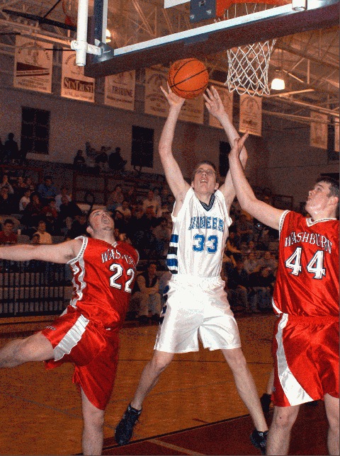 Ryan Hudson (33) gets an offensive putback over Gabe McGinnis (44) and Adam Wolfenbarger (22).