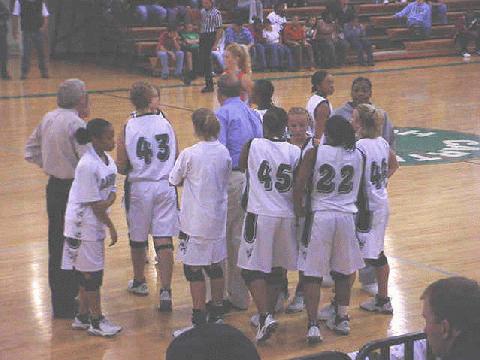 Lady Hornets discuss game plan during a :30 time-out