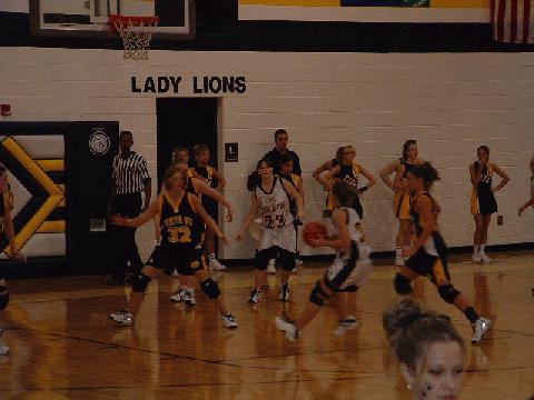 #23 Boyd looks on while #34 McIntosh drives toward the basket
