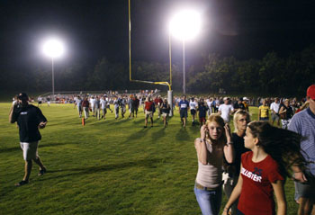 The crowd searches for shelter during the Centennial/Brentwood Academy game.