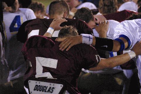 Players from both teams pray together following DA's win over CAK