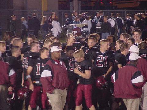 The Rebels hold the helmet high!