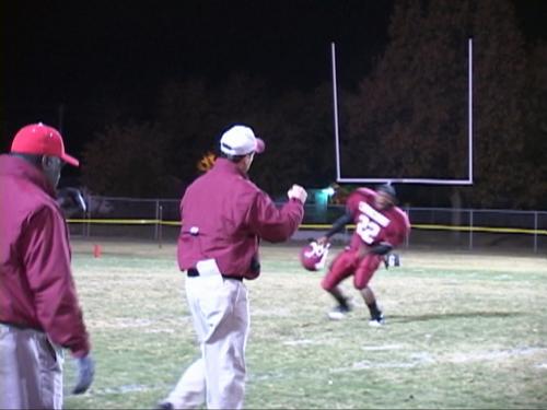 Coach P. A. Pratt pumps a fist in the air to 22 Murrell Tyus after the Cavs win a hard fought game 28-24 over Page