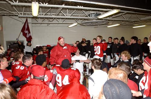 Trojans Coach Don Woods speaks to his team after the 17-14 win over Maryville.