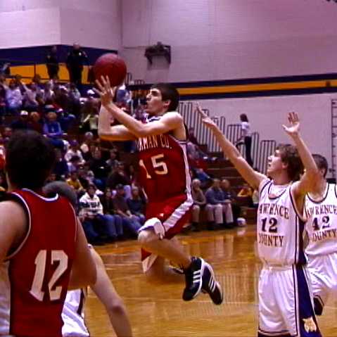 Hickman Co- #15 Matthew Dotson drives for the shot at the halftime buzzer