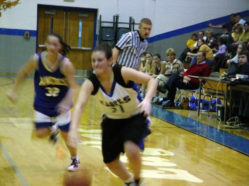 Megan Williams (white 31) drives to the basket