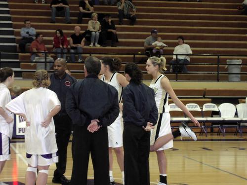 Team captains Amber strong and Stephanie Rich meet at mid court