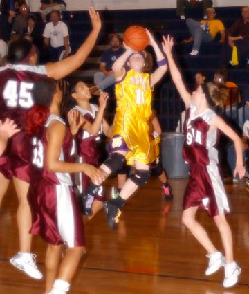 Count 'em 1-2-3-4-5 Lady Tornadoes try to stop Laura Hall.