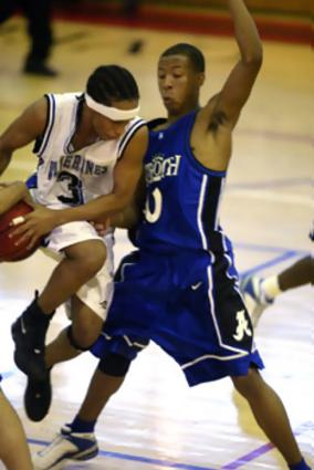 Antioch's Tywan Trice blocks the progress of LaVergne's Chris Darden during the Overton Christmas Tournament.
