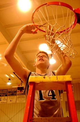 D.J. Allens cuts down the net.