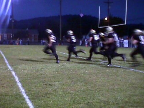 CCHS Seniors Colby Garrison (#53) and Kyle Whitlow (#5) lead the way as the Bulldogs charge onto the field before the game.