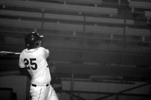 Trojan first base Zane Adams smacks a single.