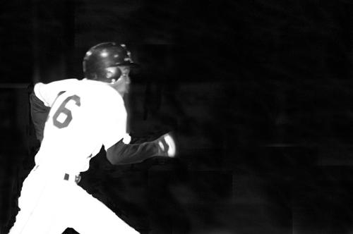 Trojan's second baseman John Wilson tries to run out a bunt.