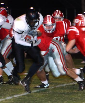 Millington's Miguel Barnes tries to break through the Germantown defense.