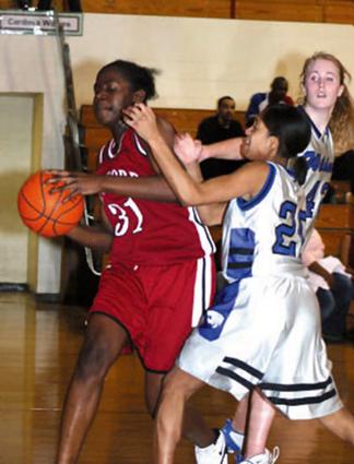 Jasmine Brown grabs another rebound.