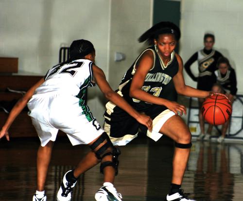 Lady Trojan Michelle Malone looks to make her move.