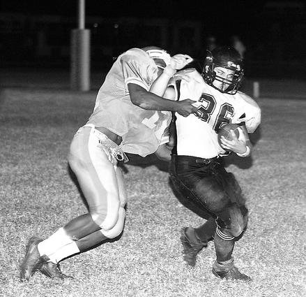 Aaron West of Millington tries to avoid the tackle.