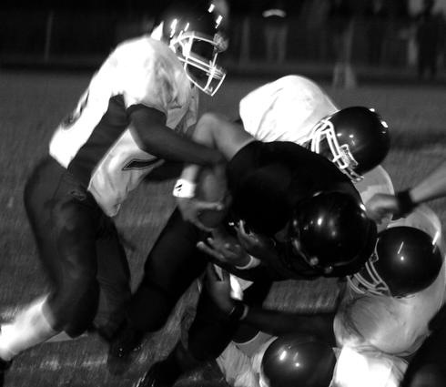 Millington quarterback Michael Bailey is tackle after a short gain.