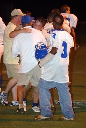 Senior Alex Hall embraces head coach Travis Tapp after snapping the 30-game losing streak.
