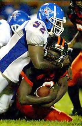 McGavock's Brandon Foxx makes a big hit to stop the first down.