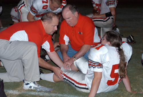 That's right; it's a girl. Hickman County's Crystal Driver (51), a senior offensive lineman, gets treatment during halftime for a leg injury that would keep her out of action in the second half.