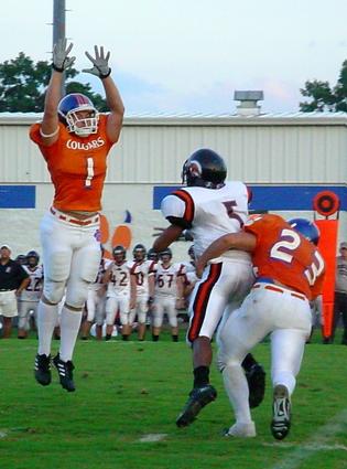 Clark Woods #1 and #23 Oscar Byrge put pressure on Clinton QB Jonathan Dye
