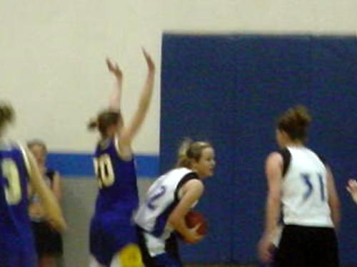 Keisha Chandler (white, left) and Julieanne Jenkins (white, right) rebound a foul shot