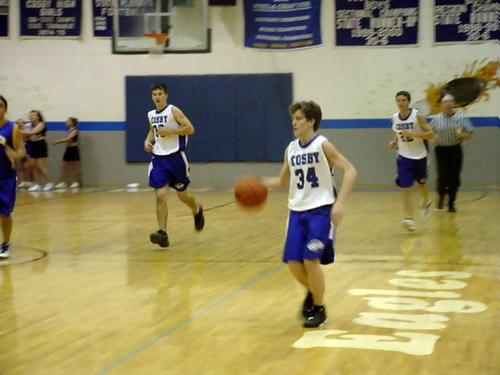 Jody Lowe (white 34) brings the ball down