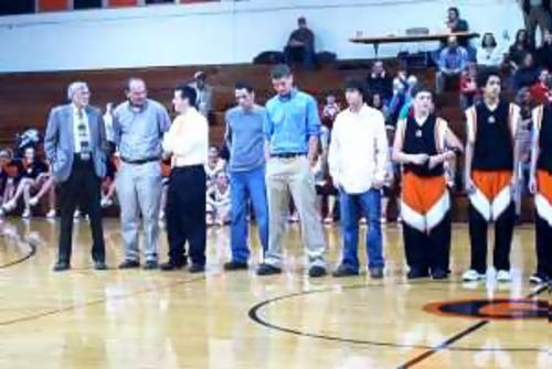 The 2003 Greenfield State Runnerup Basketball team hang their 2003 State Runnerup banner before the January 16 game against South Fulton.  The three seniors, Tyler Porter, Adam Vaughan and Chad Robinson were present for the ceremony.