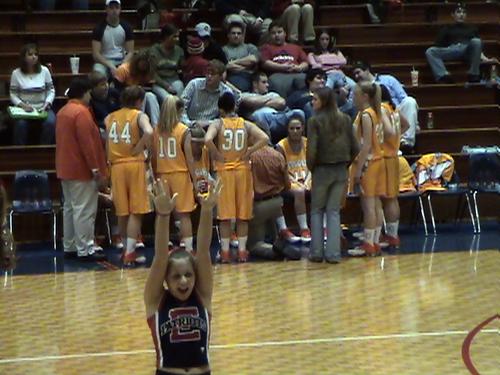 COACH GARY SURCEY TALKS WITH THE LADY COUGARS DURING A QUICK TIMEOUT...