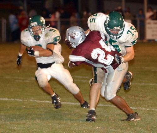 Rockwood's David Morgan runs behind the pancake block of Aaron Malone.