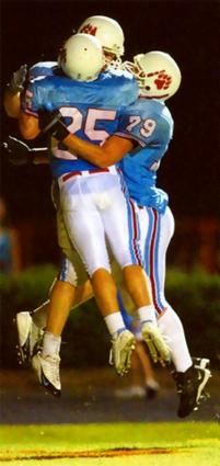  3 University School of Jackson players celebrate a TD