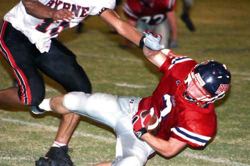 Byrne's Martin Yates makes a hit on TRA's Trey Gish.