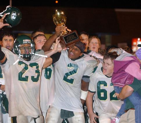 Rockwood players celebrate with the Roane County Championship trophy.