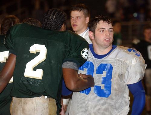 Harriman's Alex Hall (33) and Rockwood's Ellery Harvest (2) shake hands after the 85th meeting between Harriman and Rockwood.