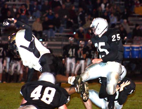 Millington's Gary Askew leaps to block Mustangs kicker Zach Miller attempt.