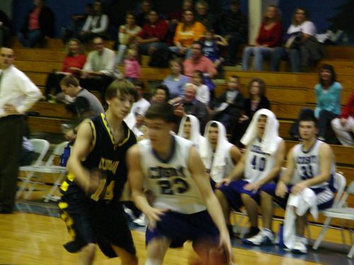 Steven Fowler (white 23) pushes under the basket